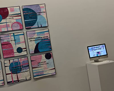 A grid of small art quilts with appliquéd circles and stitched lines of generated text, beside a monitor showing the bot that designed them.
